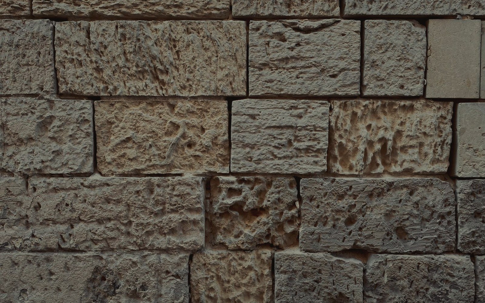 Rough-cut limestone blocks fitted together in an uneven wall pattern
