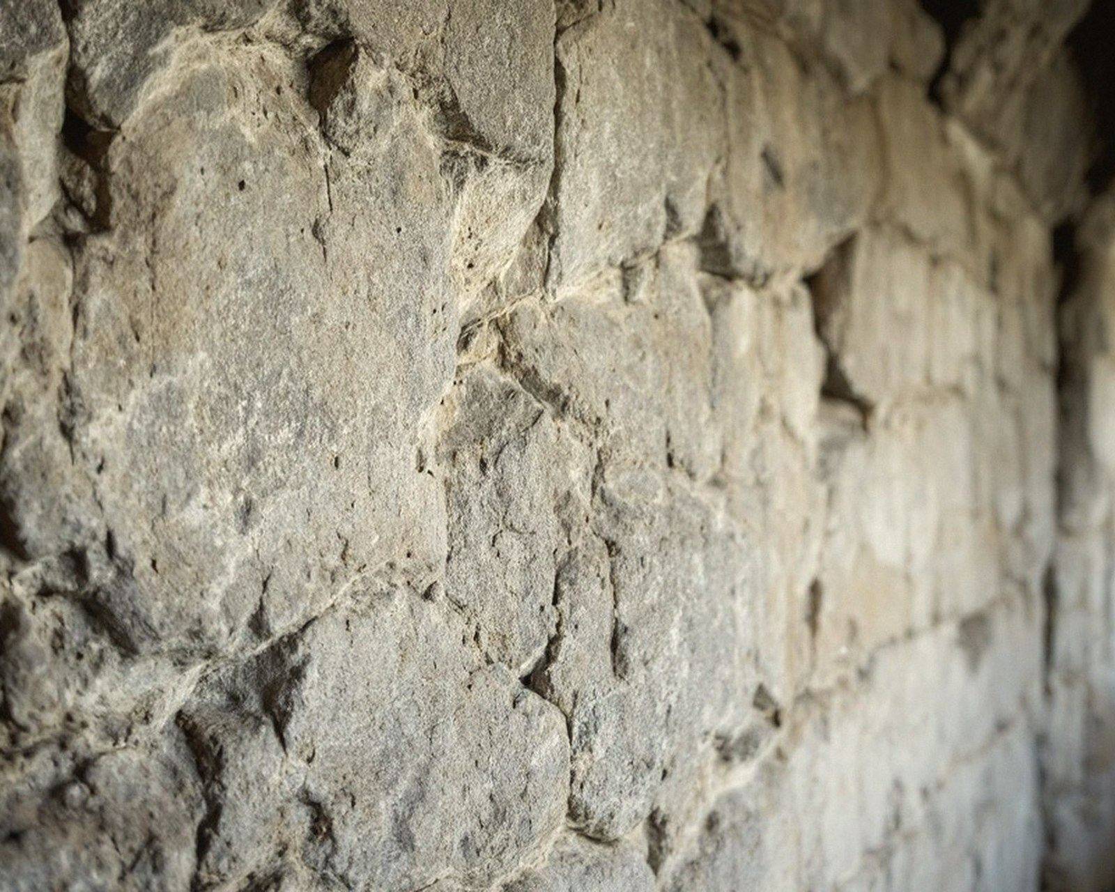 Saw marks on a gallery wall, square and parallel, side lit
